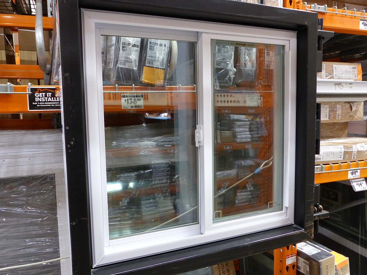 White vinyl sliding window displayed in a home improvement store
