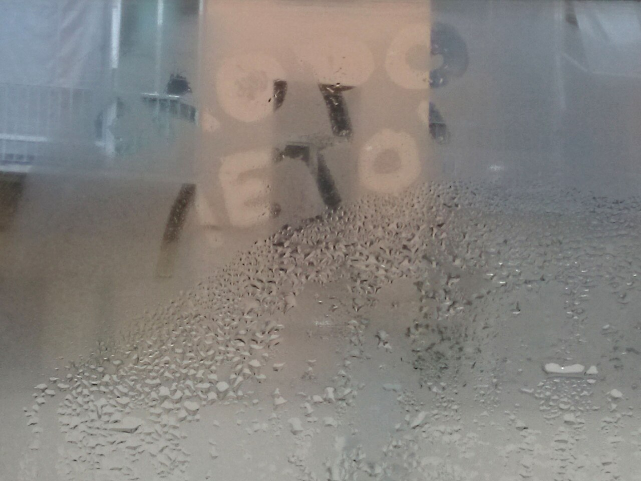 Condensation droplets forming on the interior surface of window glass